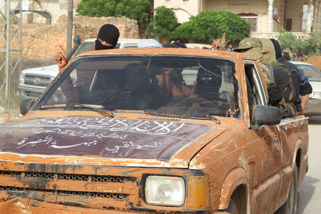 Members of al Qaeda's Nusra Front ride on a pick-up truck as they head towards their positions during an offensive to take control of the northwestern city of Ariha from forces loyal to Syria's President Bashar al-Assad, in Idlib province May 28, 2015. REUTERS/Ammar Abdullah