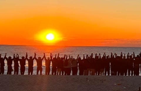 The Tennessee swimming and diving teams gathered on Wrightsville Beach for the sunrise on the last morning of their annual trip to Wilmington, North Carolina. They had a ceremony to honor the life of Ben Kredich, the son of UT swimming and diving director Matt Kredich, who died on Aug. 21.