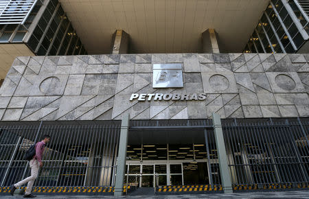 FILE PHOTO: A man walks in front of the Brazil's state-run Petrobras oil company headquarters in Rio de Janeiro, Brazil December 5, 2018. REUTERS/Sergio Moraes/File Photo