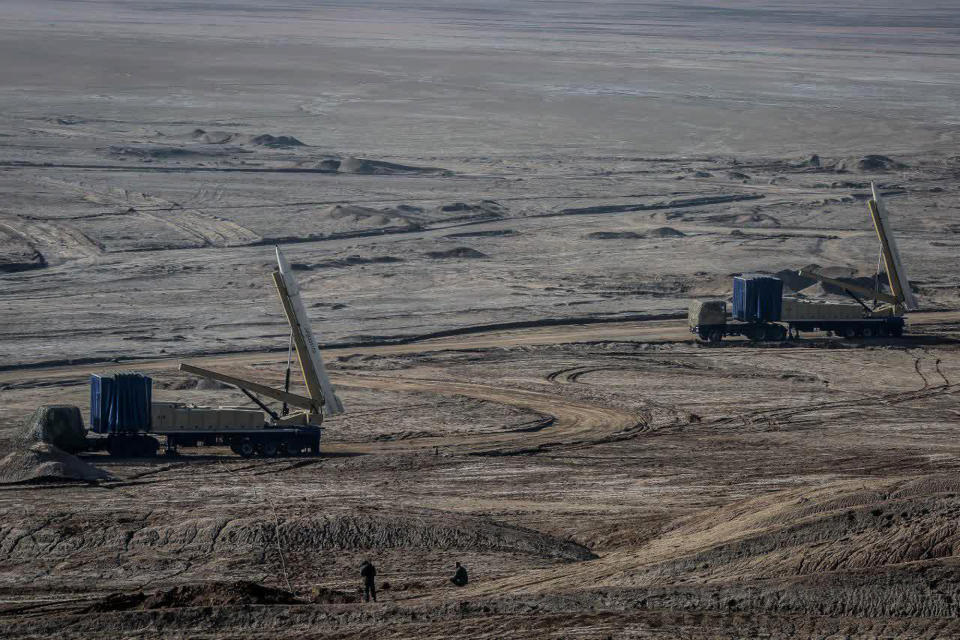 In this photo released on Friday, Jan. 15, 2021, by the Iranian Revolutionary Guard, missiles are prepared prior to be launched in a drill in Iran. Iran's paramilitary Revolutionary Guard forces on Friday held a military exercise involving ballistic missiles and drones in the country's central desert, state TV reported, amid heightened tensions over Tehran's nuclear program and a U.S. pressure campaign against the Islamic Republic. (Iranian Revolutionary Guard/Sepahnews via AP)