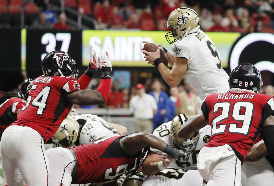 New Orleans Saints quarterback Drew Brees (9) leaps over the goal line for a touchdown against the Atlanta Falcons during overtime of an NFL football game, Sunday, Sept. 23, 2018, in Atlanta. The New Orleans Saints won 43-37. (AP Photo/David Goldman)