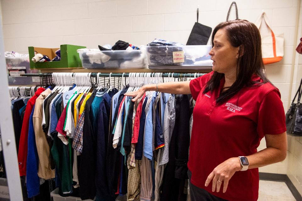 Montgomery EMA Director Christina Thornton shows clothes donations inside the Montgomery Crisis Center in Montgomery, Ala., on Thursday, Nov. 3, 2022.