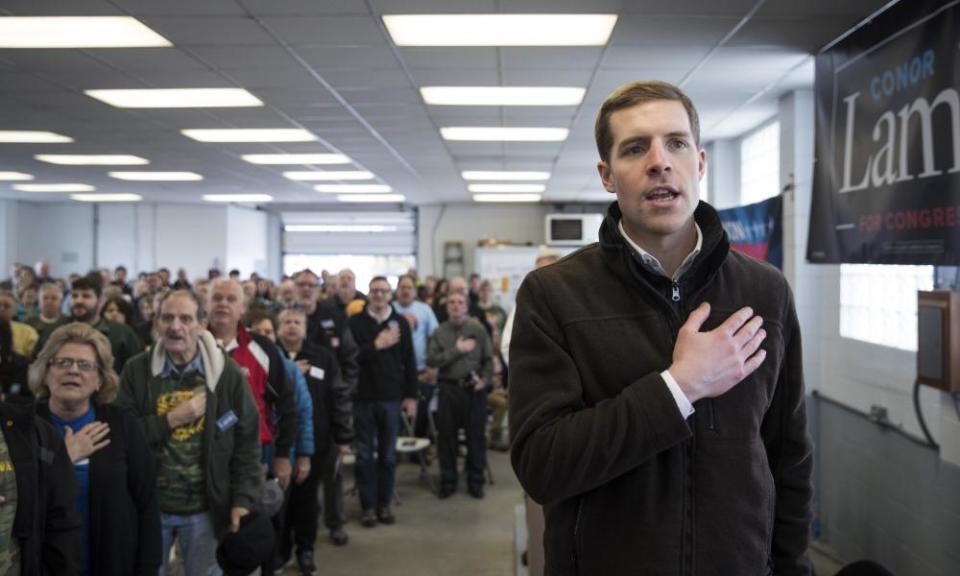 Conor Lamb recites the pledge of allegiance during a campaign rally with United Mine Workers of America at the Greene county fairgrounds Sunday in Waynesburg, Pennsylvania. 