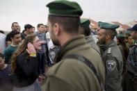 <p>A settler argues with Israeli police in the West Bank settlement of Ofra, Tuesday, Feb. 28, 2017. Israeli forces began evacuating nine homes in the settlement following a Supreme Court decision that ruled they were built on private Palestinian land. (AP Photo/Oded Balilty) </p>