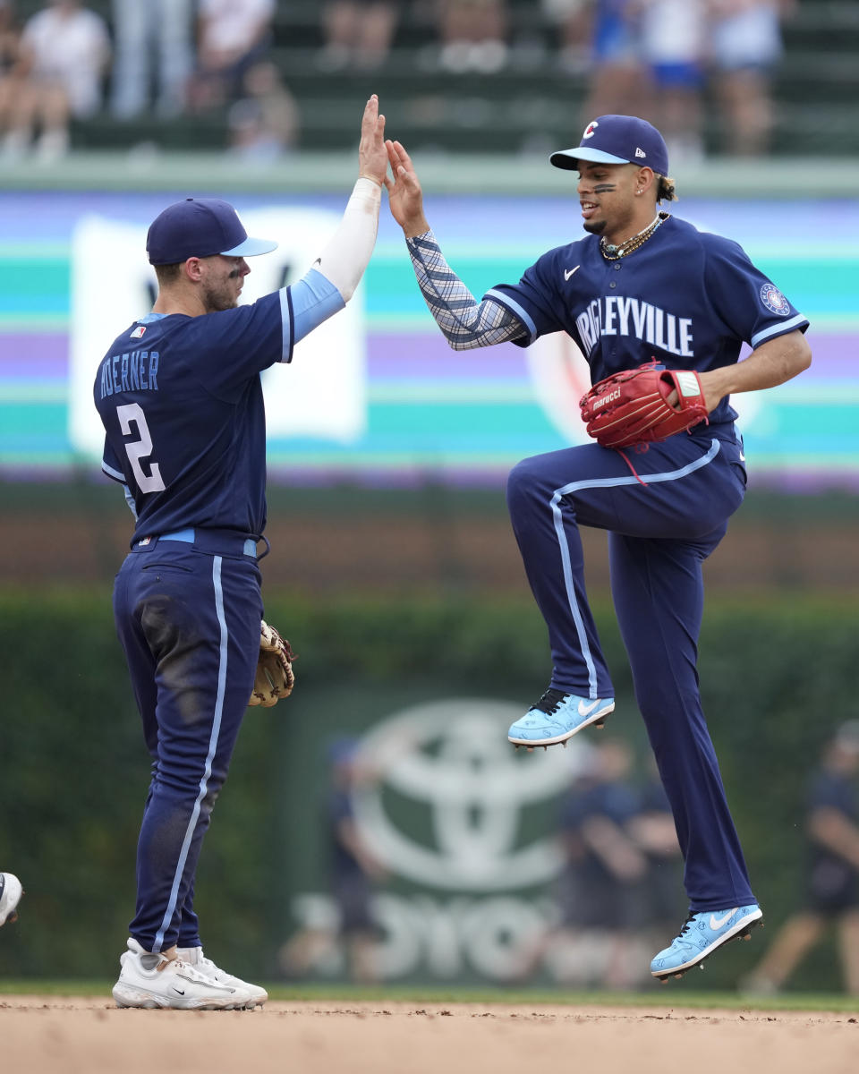 Chicago Cubs' Nico Hoerner (2) and Christopher Morel, right, celebrate after a win over the Cleveland Guardians in a baseball game Friday, June 30, 2023, in Chicago. (AP Photo/Charles Rex Arbogast)