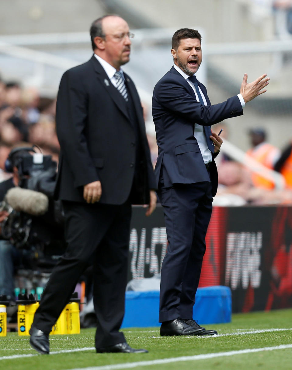 Newcastle manager Rafael Benitez and Tottenham boss Mauricio Pochettino watch their respective teams