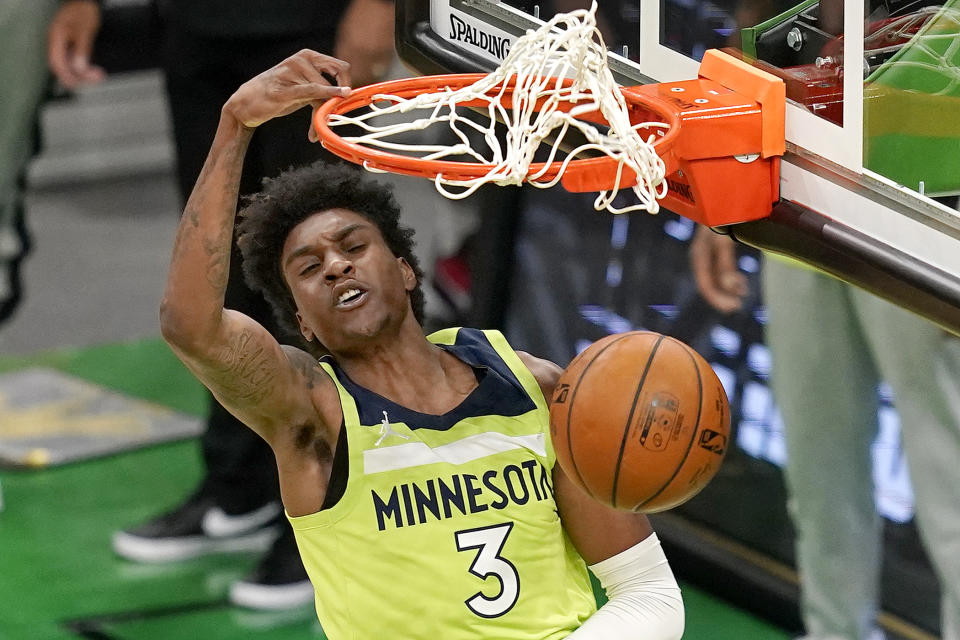 Minnesota Timberwolves forward Jaden McDaniels (3) dunks against the Boston Celtics in the first quarter of an NBA basketball game, Friday, April 9, 2021, in Boston. (AP Photo/Elise Amendola)