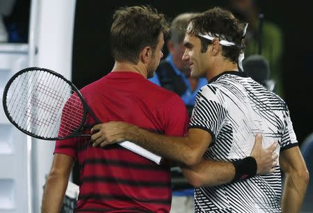 Tennis - Australian Open - Melbourne Park, Melbourne, Australia - 26/1/17 Switzerland's Roger Federer embraces after winning his Men's singles semi-final match against Switzerland's Stan Wawrinka. REUTERS/Thomas Peter