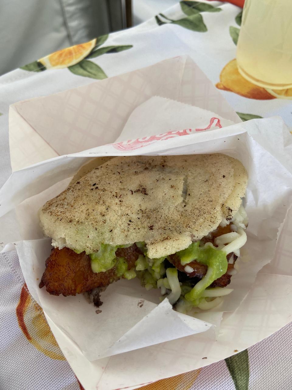 The original arepas from Sus Arepas at the Coachella Valley Music and Arts Festival is loaded up with black beans, mozzarella cheese, plantains and spicy green sauce.