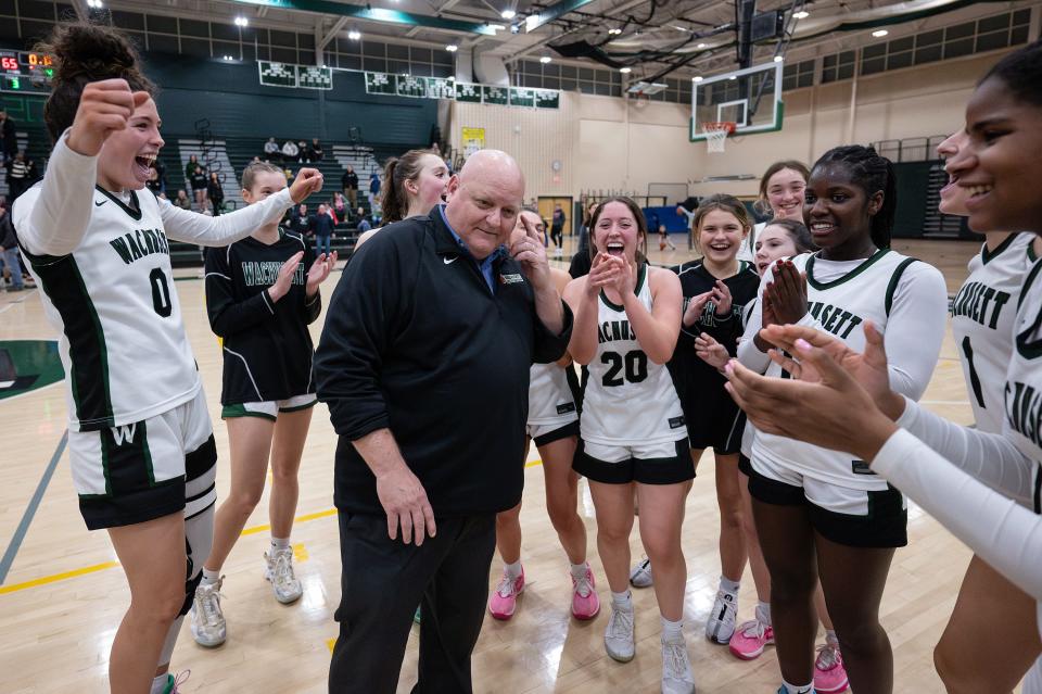 Wachusett girls' basketball coach Jim Oxford, center, is surrounded by his team as they celebrate his 300th win on Tuesday night.
