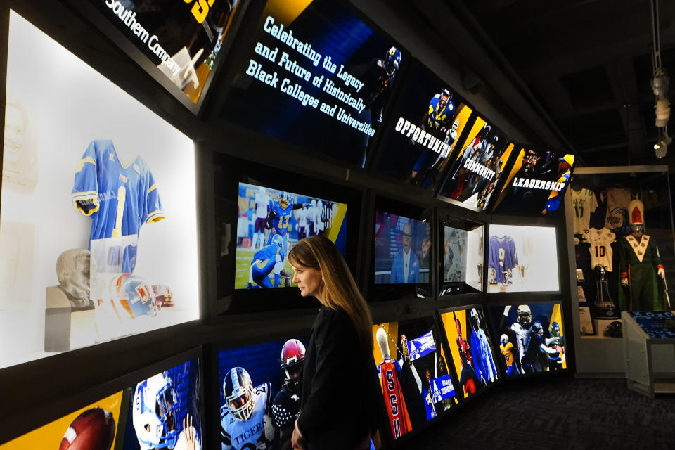 College Football Hall of Fame chief executive officer Kimberly Beaudin looks over their new exhibit dedicated to historically black colleges and universities, Thursday, Sept. 2, 2021, in Atlanta. (AP Photo/John. Bazemore)