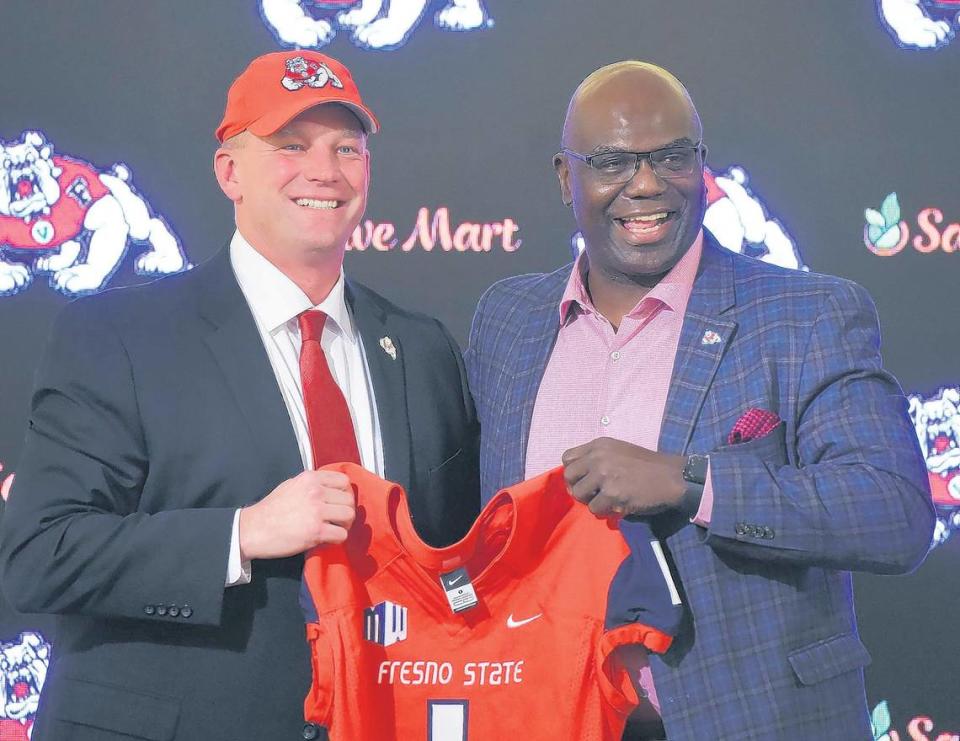 Kalen DeBoer, left, is announced as the new Fresno State Bulldogs football coach by Athletics Director Terry Tumey, right, at a news conference Tuesday afternoon, Dec, 17, 2019 in Fresno.