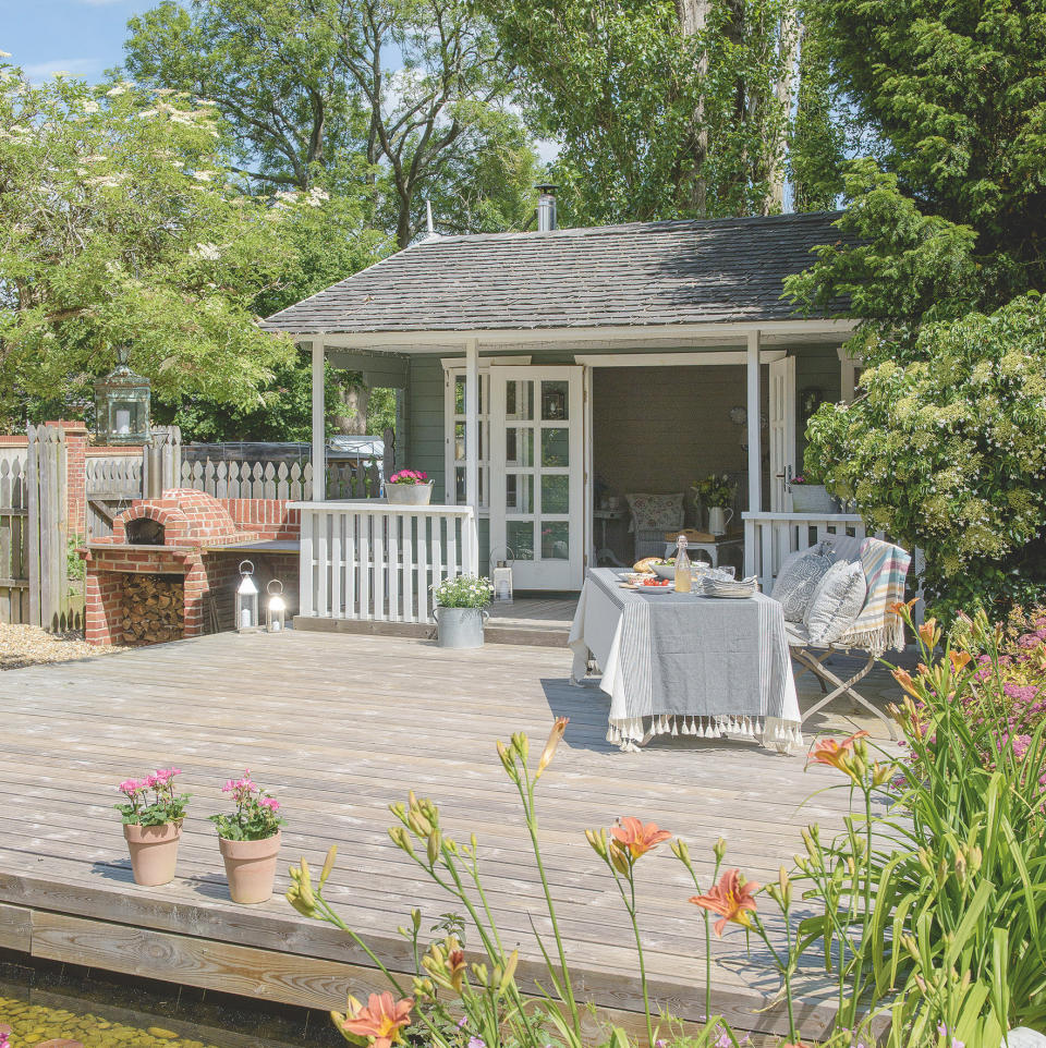 cabin with trees and chair and table