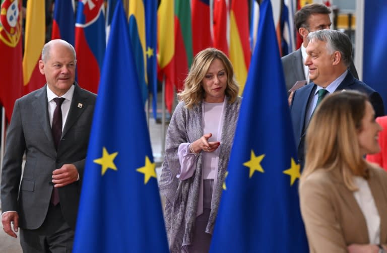 Hungary's Prime Minister Viktor Orban (R), Germany's Chancellor Olaf Scholz (L) and Italy's Prime Minister Giorgia Meloni arrive for an EU summit in Brussels (JOHN THYS)