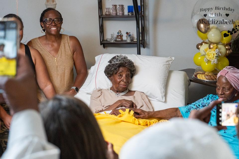 Elizabeth Francis on her 114th birthday with her daughter Dorothy Williams (R) and her granddaughter Ethel Harrison (L).