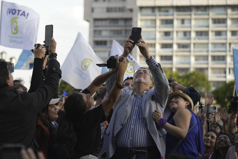 Guatemalan presidential candidate Bernardo Arevalo of the Semilla party takes a selfie with his supporters at Constitution Square in Guatemala City, Monday, June 26, 2023. Arevalo and former first lady Sandra Torres of the UNE party are going to an Aug. 20 presidential runoff. (AP Photo/Moises Castillo)
