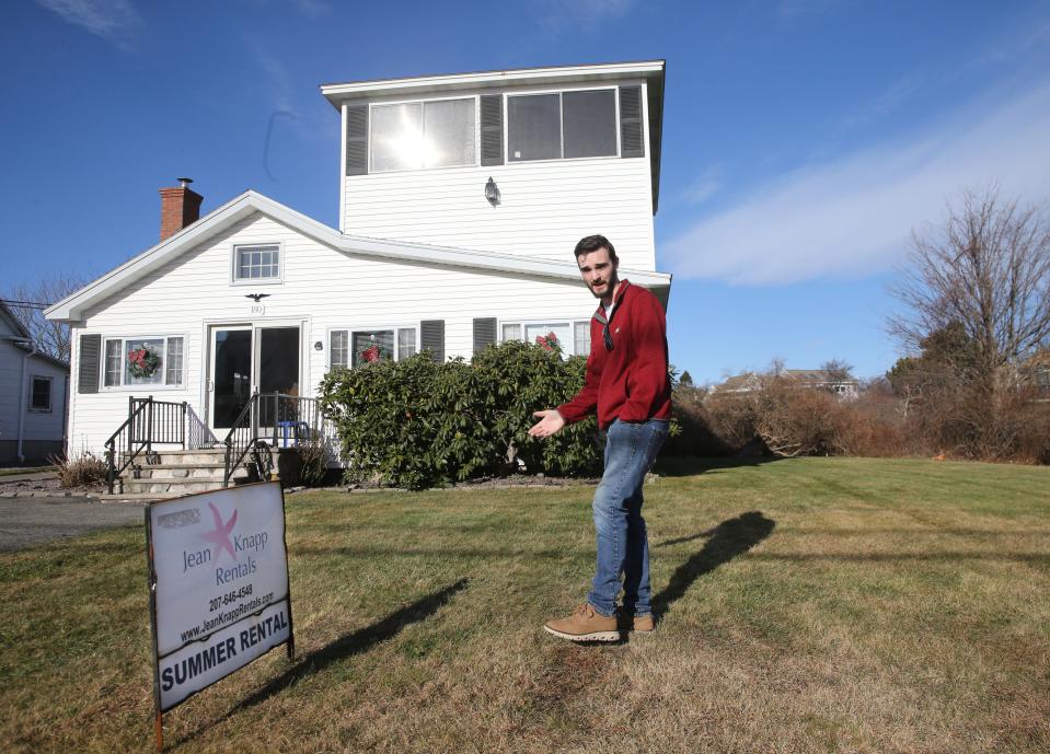 John Guy, an agent of Jean Knapp Rentals, poses in front of a short-term rental property on Nubble Road in York. The house is one of the many that could be affected by new regulations on short-term rentals in the town.