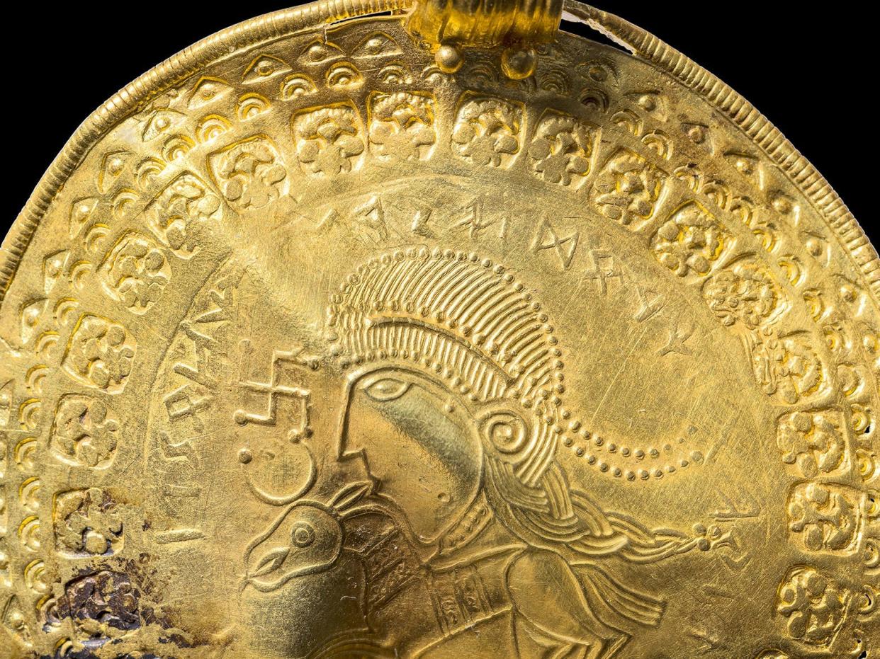 Ancient gold disc showing the worlds oldest inscription referring to Norse god Odin