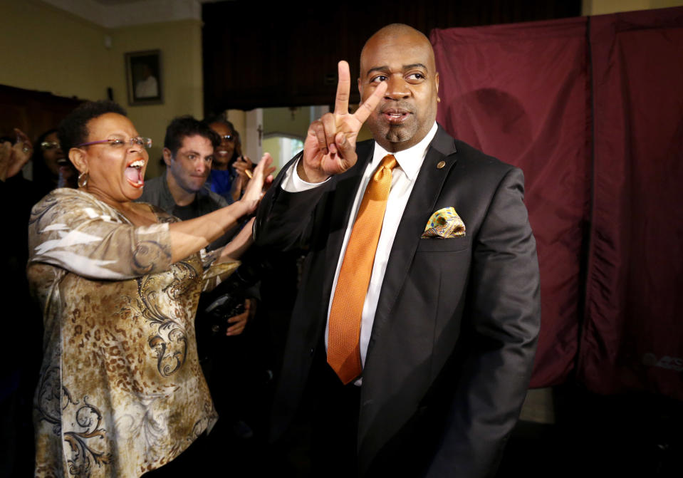 Newark mayoral candidate Ras Baraka, right, is greeted by supporters after casting his vote, Tuesday, May 13, 2014, in Newark, N.J. Tuesday's election will decide whether Shavar Jeffries, a former state assistant attorney general, or Baraka, a city councilman, will take over the seat Cory Booker occupied from 2006 until October 2013, when he won a special election to succeed U.S. Sen. Frank Lautenberg, who died in office. (AP Photo)