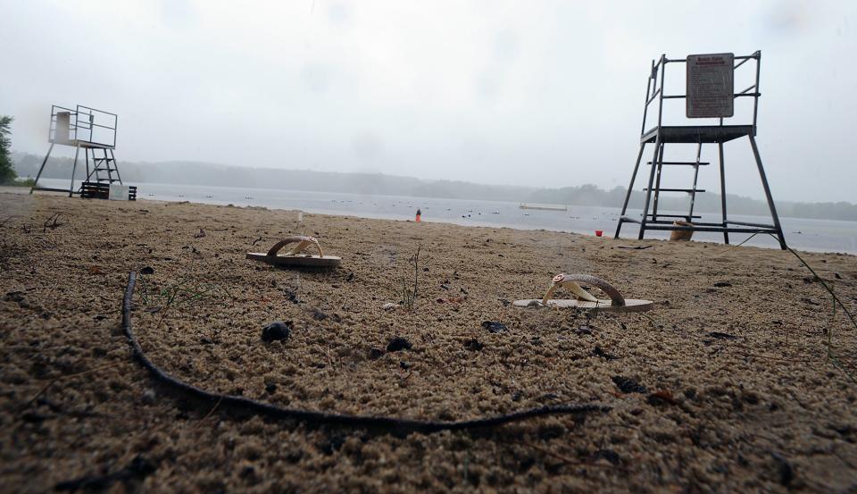 Sandals left behind on a rainy Thursday at Pleasure Point Beach on Lake Winthrop at Stoddard Park in Holliston, August 5, 2021. 