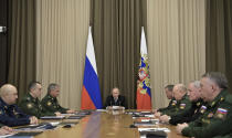 Russian President Vladimir Putin, background center, speaks during a meeting with top military officers in the Bocharov Ruchei residence in the Black Sea resort of Sochi, Russia, Monday, Nov. 19, 2018. Putin has gathered his top military officials to discuss a response to the planned U.S. withdrawal from a key nuclear arms pact. (Alexei Nikolsky, Sputnik, Kremlin Pool Photo via AP)