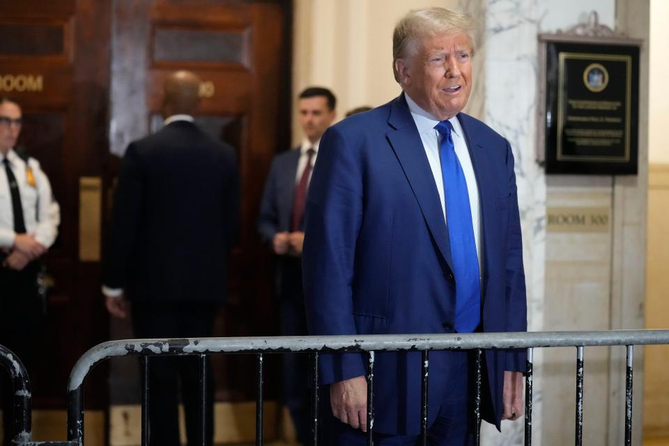 Former President Donald Trump speaks before entering the courtroom for the continuation of his civil business fraud trial at New York Supreme Court on 25 October 2023 (AP)