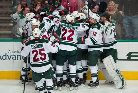 Apr 22, 2016; Dallas, TX, USA; The Minnesota Wild celebrate center Mikko Koivu (9) game winning goal against the Dallas Stars during the overtime period in game five of the first round of the 2016 Stanley Cup Playoffs at the American Airlines Center. Mandatory Credit: Jerome Miron-USA TODAY Sports