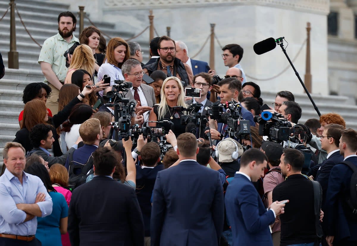 WASHINGTON, DC - MAY 08: U.S. Rep. Marjorie Taylor Greene (R-GA), trailed by Rep. Thomas Massie (R-KY), speaks to members of the press while exiting the U.S. Capitol after introducing a motion to vacate on the floor of the House of Representatives seeking to remove Speaker of the House Mike Johnson (R-LA) from his leadership position May 8, 2024 in Washington, DC. The House voted 359 to 43 to table the motion to vacate. (Photo by Kevin Dietsch/Getty Images) (Getty Images)