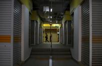 FILE PHOTO: A woman passes closed shops, during the "circuit breaker" measures to curb the coronavirus outbreak (COVID-19), in Singapore's Chinatown