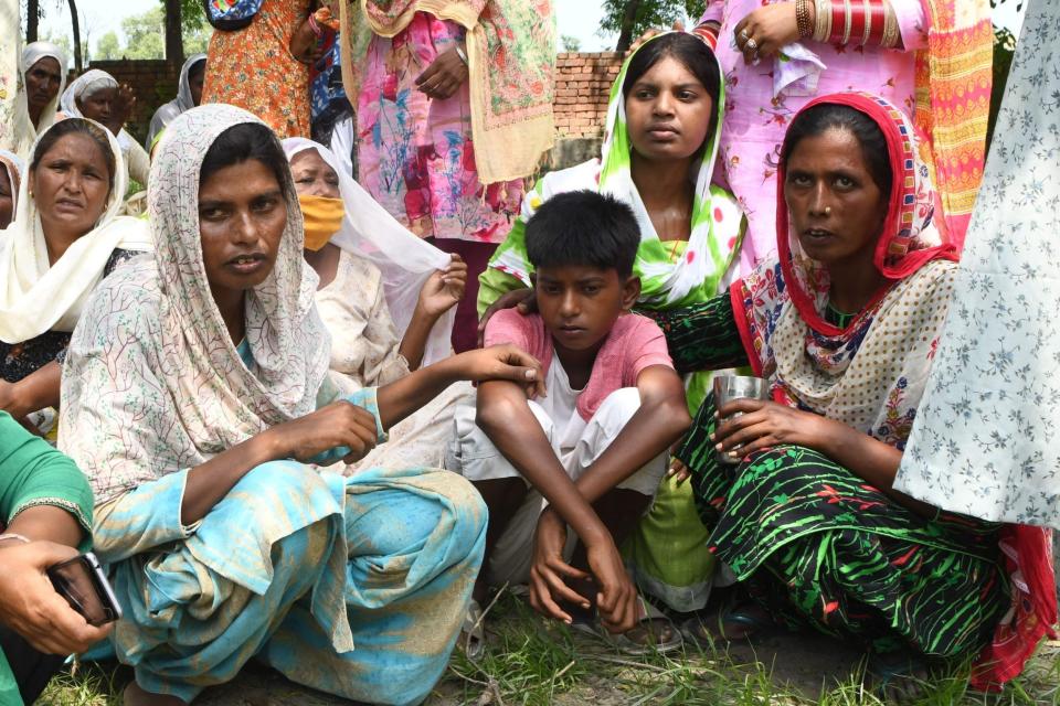 Relatives reacts during the cremation of Kirpal Singh, who died after allegedly drinking spurious alcohol (AFP via Getty Images)