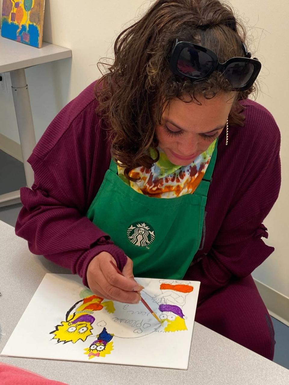 Monique Moore paints in art class at the Meadowview Navigation Center on Saturday, Nov. 21, 2020.