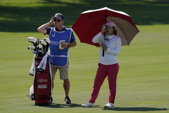 Ayaka Furue, right, of Japan, checks her distance with her caddie Michael Scott during the first round of the MEDIHEAL Championship golf tournament Thursday, Oct. 6, 2022, in Somis, Calif. (AP Photo/Mark J. Terrill)