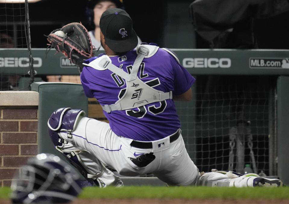 Colorado Rockies catcher Elias Diaz catches a foul ball off the bat of Milwaukee Brewers' Omar Narvaez in the ninth inning of a baseball game Tuesday, Sept. 6, 2022, in Denver. (AP Photo/David Zalubowski)