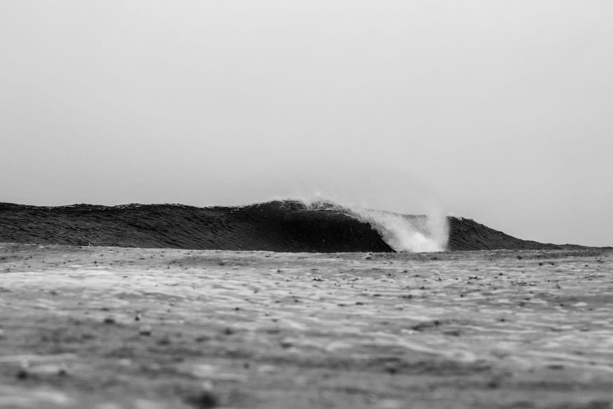 A surprisingly pristine wave breaks at a typically chaotic local beach break. Despite the rainy afternoon and the presence of surfers, this serene little lineup ended up being the shot of this specific session<p>Marcus Paladino</p>