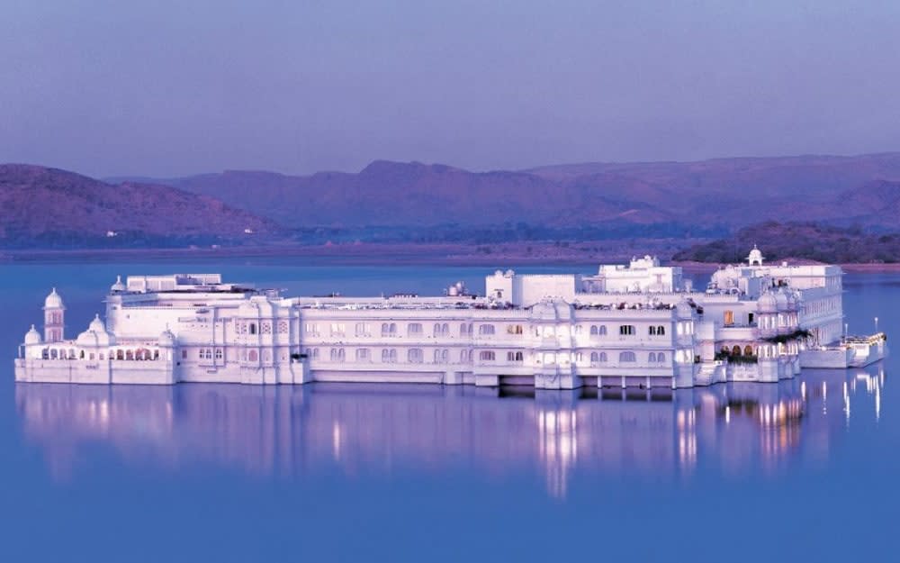 The Taj Lake Palace floats like a beautiful white ship on the waters of Lake Pichola, with 360-degree views of surrounding Udaipur. 