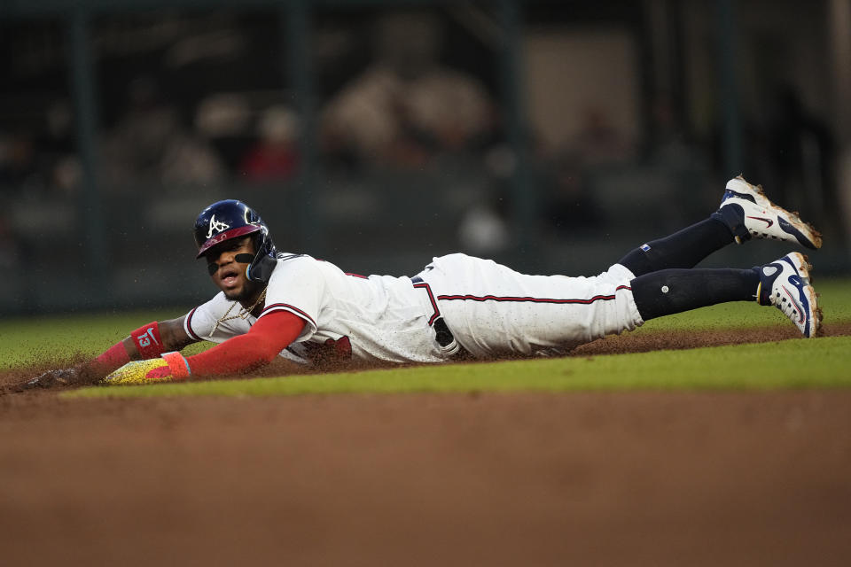 Atlanta Braves right fielder Ronald Acuna Jr. steals second base against the Cincinnati Reds during the second inning of a baseball game Wednesday, April 12, 2023, in Atlanta. (AP Photo/John Bazemore)