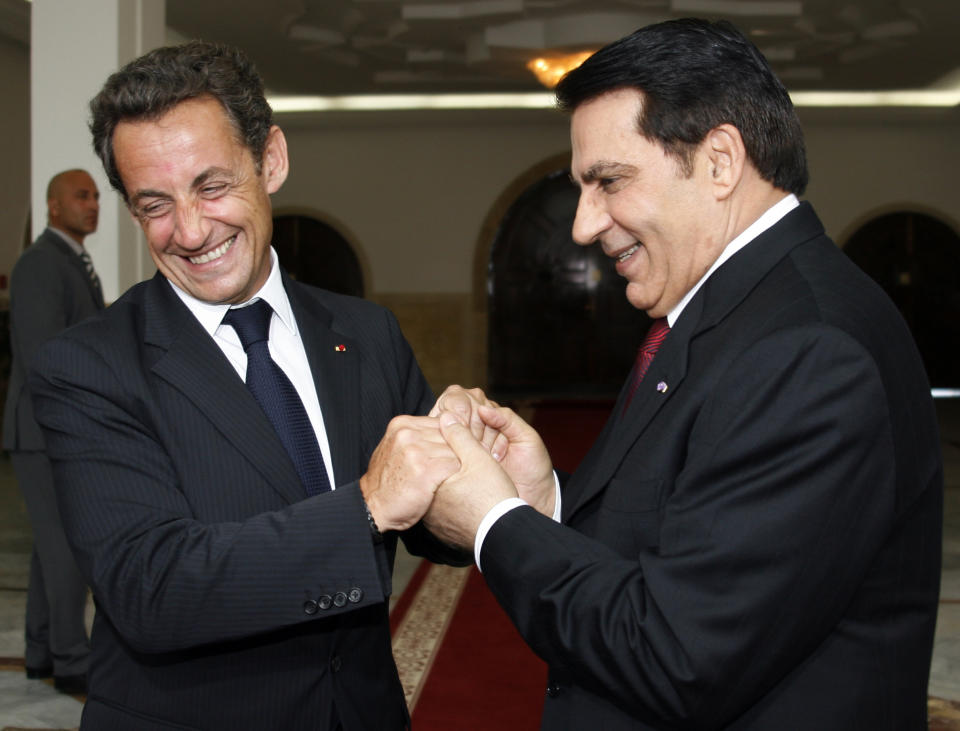 FILE - In this July 10 2007 file photo, French President Nicolas Sarkozy, left, is greeted by Tunisian President Zine El Abidine Ben Ali during a welcoming ceremony in Tunis. Tunisia's autocratic ruler Zine El Abidine Ben Ali, toppled in 2011, died in exile in Saudi Arabia. (Jean-Paul Pelissier, Pool via AP, File)