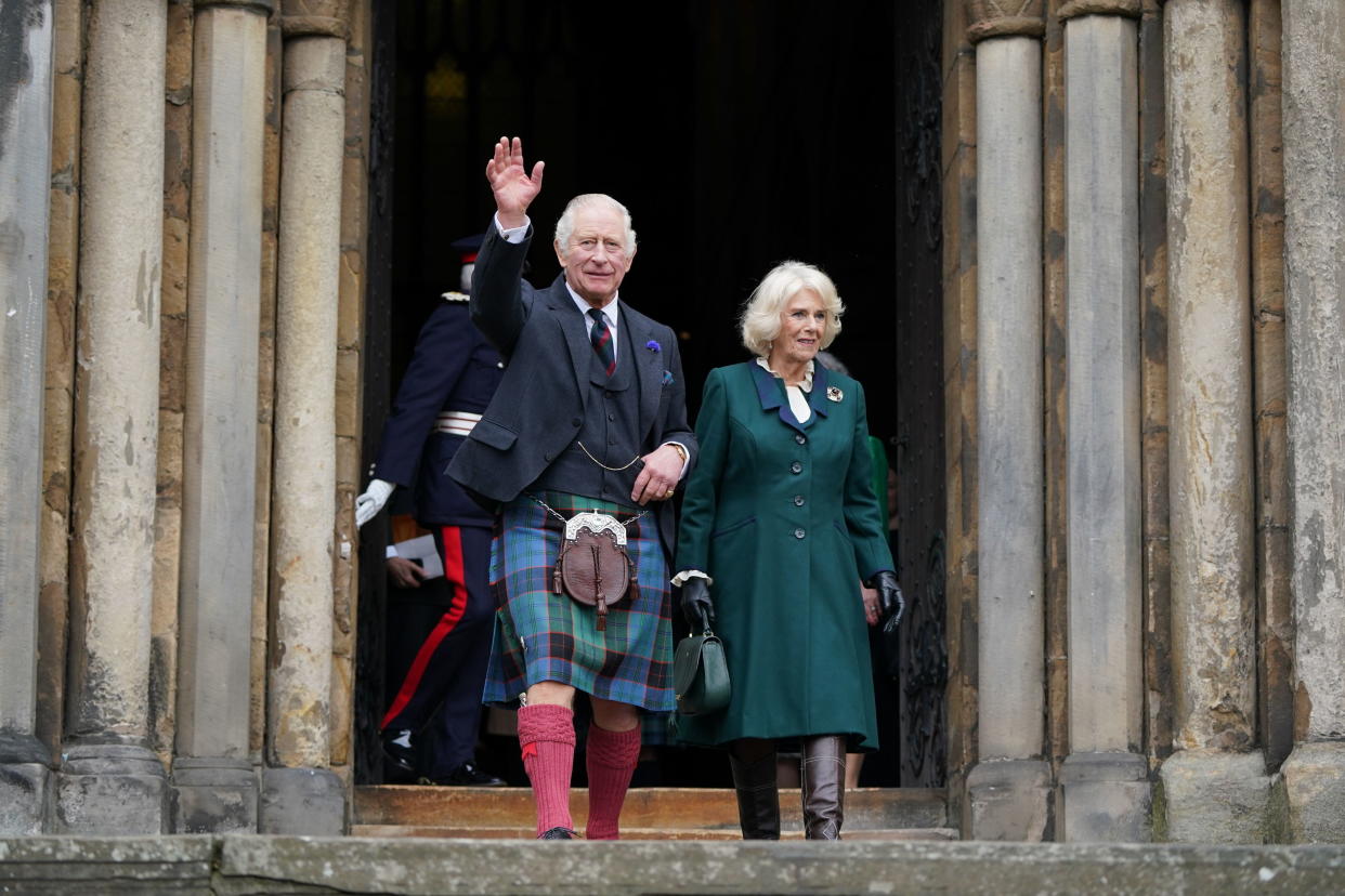 Britain's King Charles III and Camilla, the Queen Consort, leave Dunfermline Abbey after a visit to mark its 950th anniversary, and after attending a meeting at the City Chambers in Dunfermline, Fife, where the King formally marked the conferral of city status on the former town. (Andrew Milligan/PA via AP)