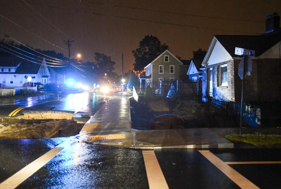 The night of Sept. 11: Floodwaters washed away a second of Pleasant Street and the front yard of the Obin family.