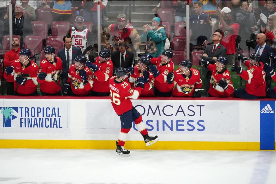 Nov 10, 2023; Sunrise, Florida, USA; Florida Panthers defenseman Uvis Balinskis (26) celebrates with teammates after scoring a goal against the Carolina Hurricanes during the first period at Amerant Bank Arena.