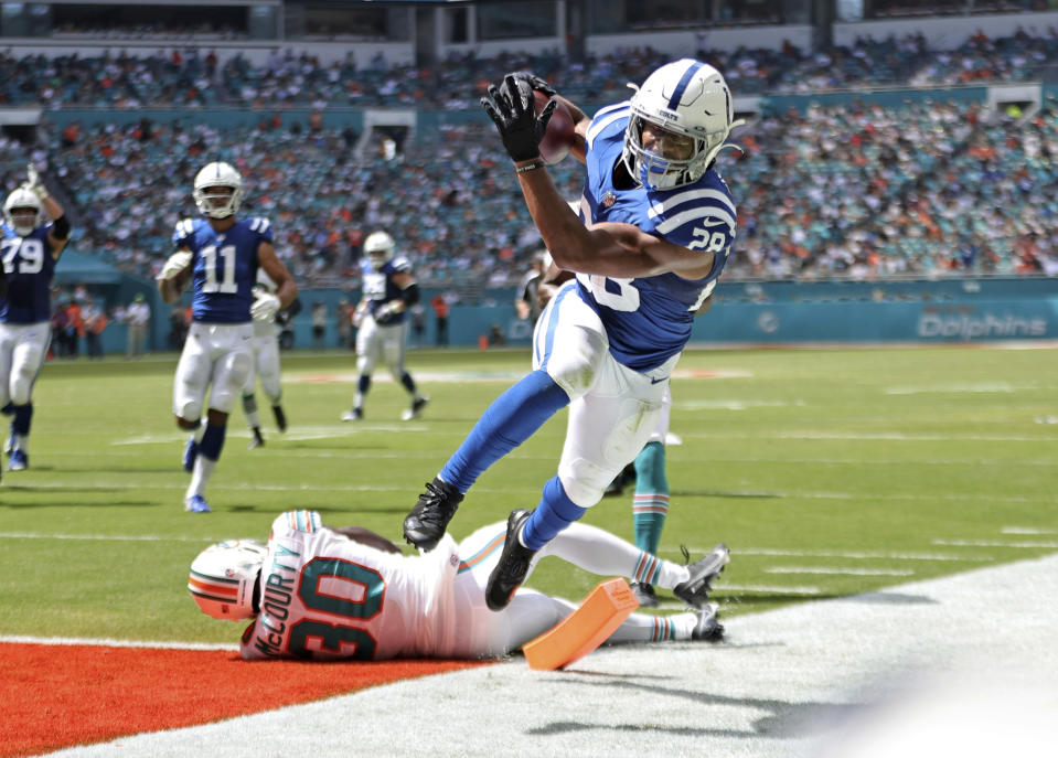 Indianapolis Colts running back Jonathan Taylor (28) runs for a touchdown against Miami Dolphins strong safety Jason McCourty (30) during the second quarter of an NFL football game Sunday, Oct. 3, 2021, in Miami Gardens, Fla. (David Santiago/Miami Herald via AP)