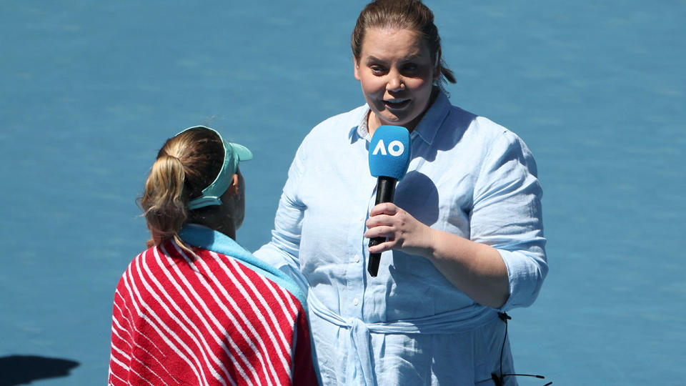 Jelena Dokic conducts an interview on court at the Australian Open.