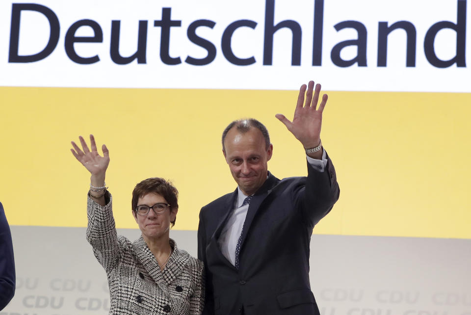 FILE - In this Dec. 7, 2018 file photo, newly elected CDU chairwoman Annegret Kramp-Karrenbauer, left, and Friedrich Merz, right, wave during the party convention of the Christian Democratic Party CDU in Hamburg, Germany. Friday, Dec. 7, 2018. Merz a one-time rival of German Chancellor Angela Merkel has assailed her leadership style, adding to tensions in her center-right party after a dismal state election performance in Thuringia on Sunday, Oct. 27, 2019. Friedrich Merz ran last year to succeed Merkel as leader of her Christian Democratic Union but was narrowly defeated by Annegret Kramp-Karrenbauer. (AP Photo/Michael Sohn, file)