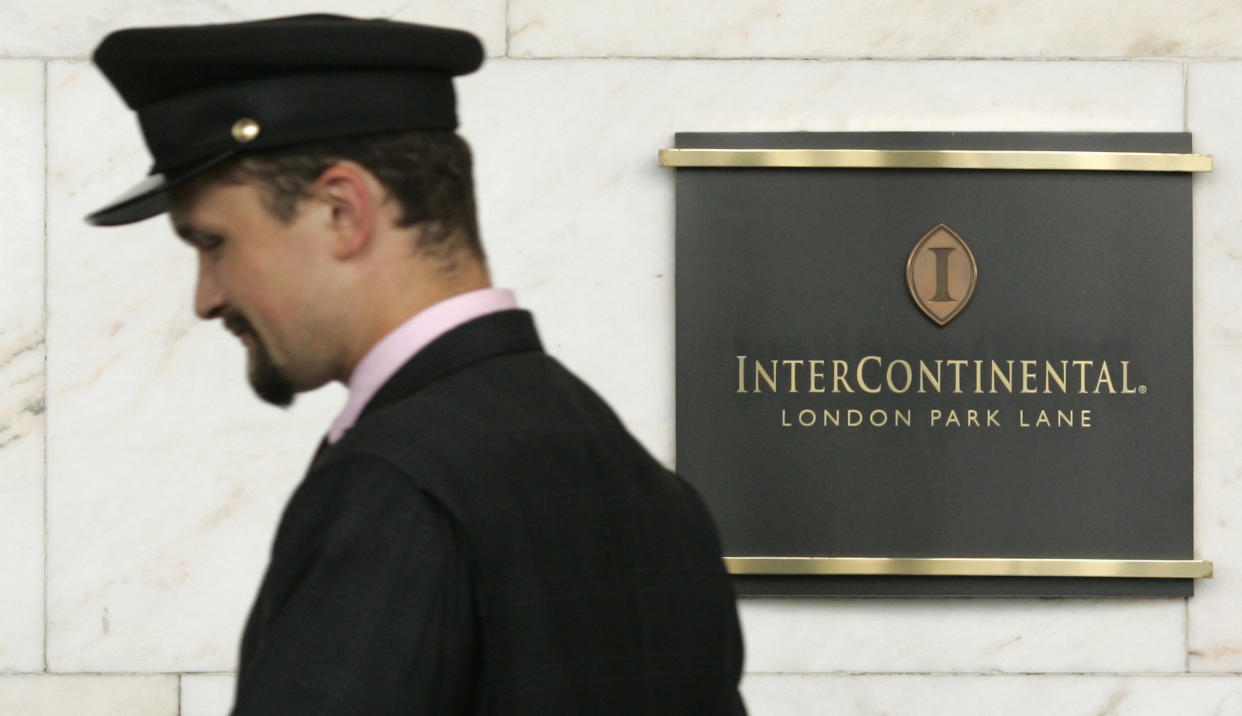 IHG A porter passes a sign for the InterContinental Hotel, Park Lane in London August 11, 2008. The world's No.1 hotelier InterContinental Hotels Plc met forecasts with a 29 percent rise in first-half profits, and warned that growth had slowed in the second-quarter, particularly in the United States. The British group, which operates InterContinental, Crowne Plaza and Holiday Inn hotels, posted first-half operating profits from continuing operations of $284 million on Tuesday, in line with an analysts range of $281-290 million and a mean forecast of $285 million.  Picture taken August 11.    REUTERS/Luke MacGregor    (BRITAIN)