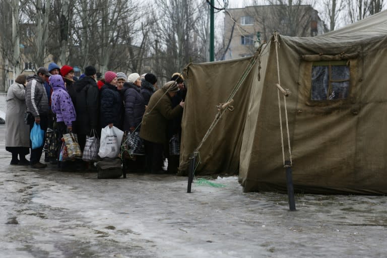 Residents of the war-scarred and cashed-starved Ukraine queue outside a tent to get warm clothes in Avdiivka, Donetsk region, on February 5, 2017
