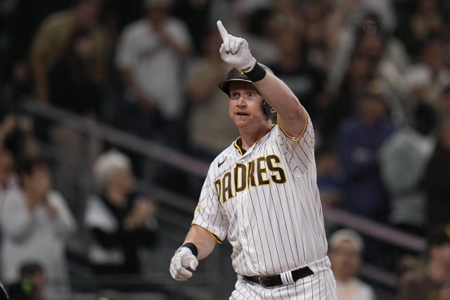 San Diego Padres' Garrett Cooper, right, celebrates with third