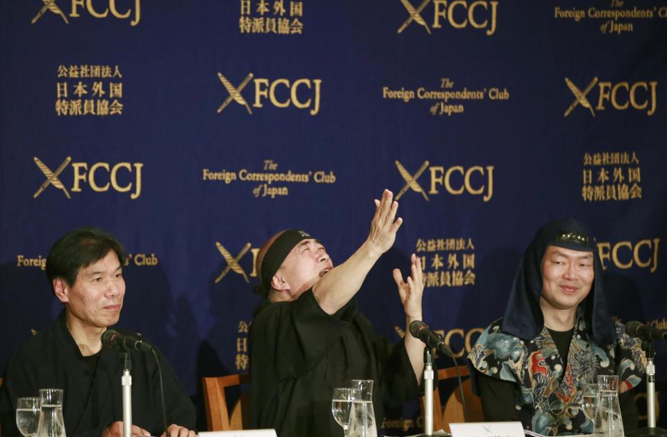 Japan Ninja Council vice chairman Hiroshi Mizohata, center, gestures as ninja scholar Junichi Kawakami, left, and Mie University Prof. Yuji Yamada smile during a press conference at Foreign Correspondents' Club of Japan in Tokyo, Wednesday, Feb. 22, 2017. The Japan Ninja Council, a government-backed organization of scholars, tourism groups and businesses, said that it's starting a Ninja Academy to train people in the art of ninja, and building a new museum in Tokyo devoted to ninja, hooded samurai-era acrobatic spies, set to open in 2018. (AP Photo/Shizuo Kambayashi)
