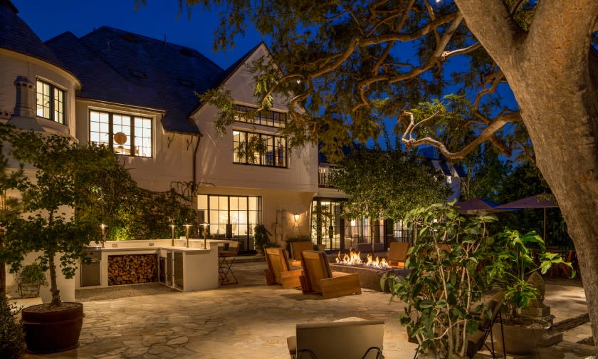 The ivy-draped traditional spans 10,400 square feet with five bedrooms and nine bathrooms.