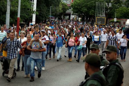 People walk to cross over the Simon Bolivar international bridge to Colombia to take advantage of the temporary border opening in San Antonio del Tachira, Venezuela, July 17, 2016. REUTERS/Carlos Eduardo Ramirez