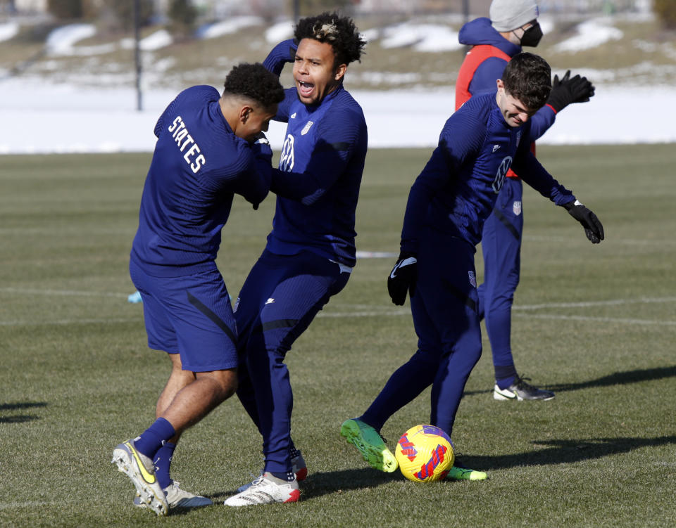 U.S. men's national team soccer midfielder Tyler Adams, left, midfielder Weston McKennie, center, and forward Christian Pulisic practice in Columbus, Ohio, Wednesday, Jan. 26, 2022, ahead of Thursday's World Cup qualifying match against El Salvador. (AP Photo/Paul Vernon)